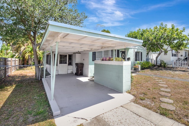 953 Churchill Rd, West Palm Beach, FL 33405 - view of front of home with stucco siding and a carport