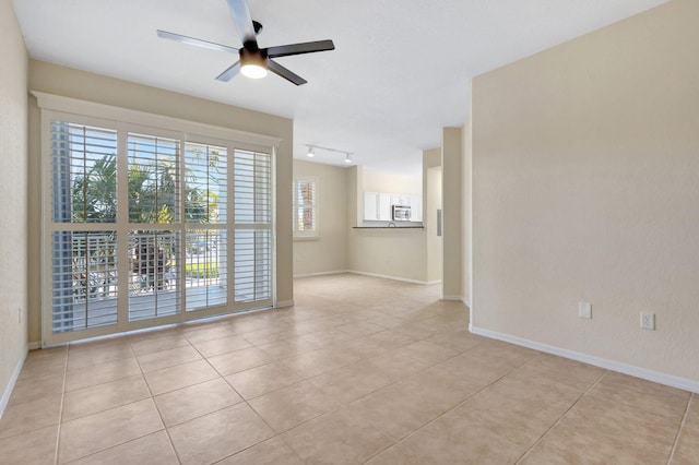 11039 Legacy Blvd Unit 203, Palm Beach Gardens, FL 33410 - unfurnished room with track lighting, baseboards, a ceiling fan, and light tile patterned flooring