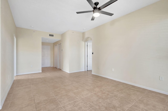 11039 Legacy Blvd Unit 203, Palm Beach Gardens, FL 33410 - unfurnished room with ceiling fan, arched walkways, baseboards, and light tile patterned floors