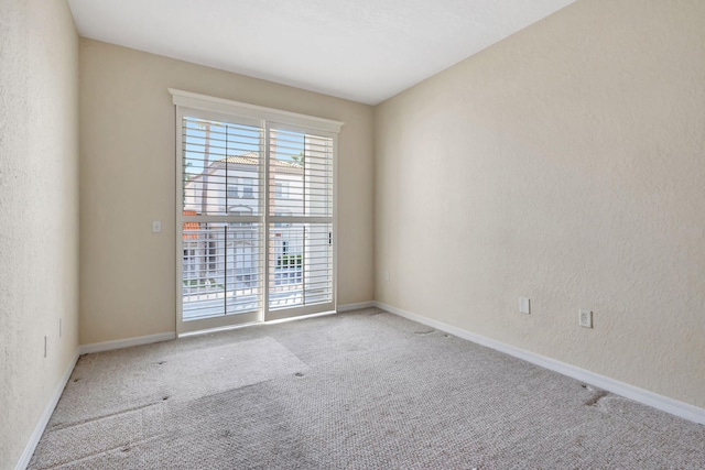 11039 Legacy Blvd Unit 203, Palm Beach Gardens, FL 33410 - empty room with a textured wall, baseboards, and carpet floors