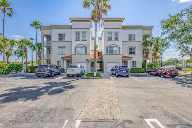11039 Legacy Blvd Unit 203, Palm Beach Gardens, FL 33410 - view of building exterior featuring uncovered parking