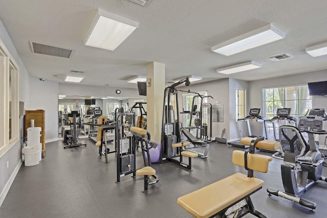 11039 Legacy Blvd Unit 203, Palm Beach Gardens, FL 33410 - gym featuring a textured ceiling, visible vents, and baseboards