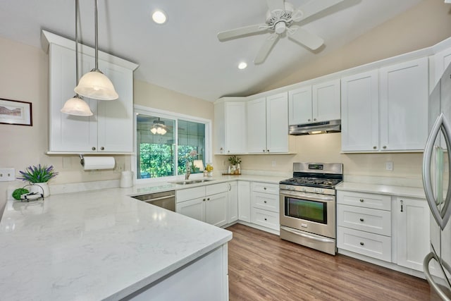 527 10th Ct, Vero Beach, FL 32962 - kitchen featuring appliances with stainless steel finishes, under cabinet range hood, ceiling fan, white cabinetry, and vaulted ceiling