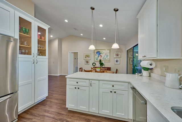 527 10th Ct, Vero Beach, FL 32962 - kitchen featuring stainless steel appliances, a peninsula, white cabinetry, lofted ceiling, and glass insert cabinets