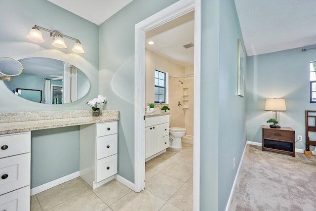 527 10th Ct, Vero Beach, FL 32962 - bathroom featuring vanity, a shower, baseboards, and toilet