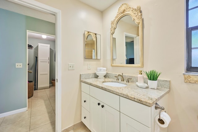 527 10th Ct, Vero Beach, FL 32962 - bathroom with vanity, tile patterned flooring, and baseboards