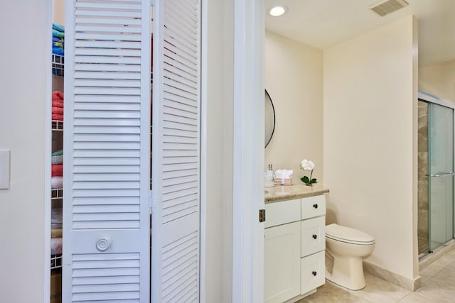 527 10th Ct, Vero Beach, FL 32962 - bathroom with a closet, a shower stall, toilet, tile patterned floors, and vanity