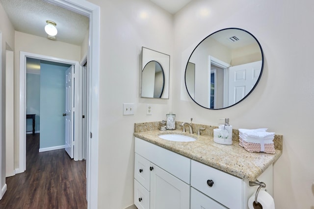 527 10th Ct, Vero Beach, FL 32962 - bathroom featuring wood finished floors, vanity, and baseboards