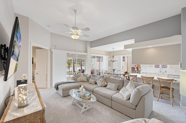8483 Beaconhill Rd, Palm Beach Gardens, FL 33410 - living area featuring light colored carpet, a ceiling fan, a chandelier, and a towering ceiling