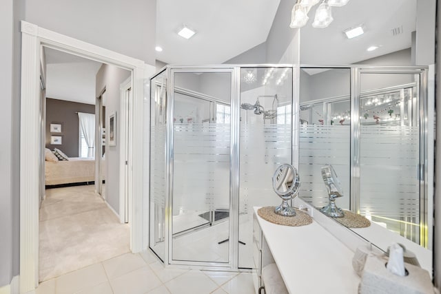 8483 Beaconhill Rd, Palm Beach Gardens, FL 33410 - ensuite bathroom featuring tile patterned floors and vaulted ceiling