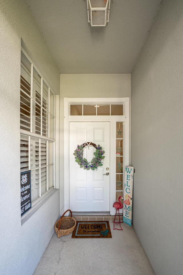 8483 Beaconhill Rd, Palm Beach Gardens, FL 33410 - view of exterior entry with stucco siding