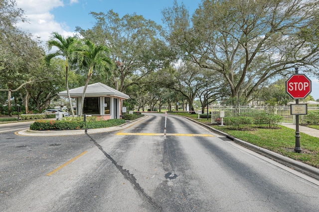 8483 Beaconhill Rd, Palm Beach Gardens, FL 33410 - view of asphalt street with traffic signs and curbs