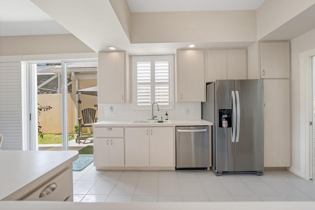 8483 Beaconhill Rd, Palm Beach Gardens, FL 33410 - kitchen with stainless steel appliances, a sink, light countertops, backsplash, and light tile patterned floors