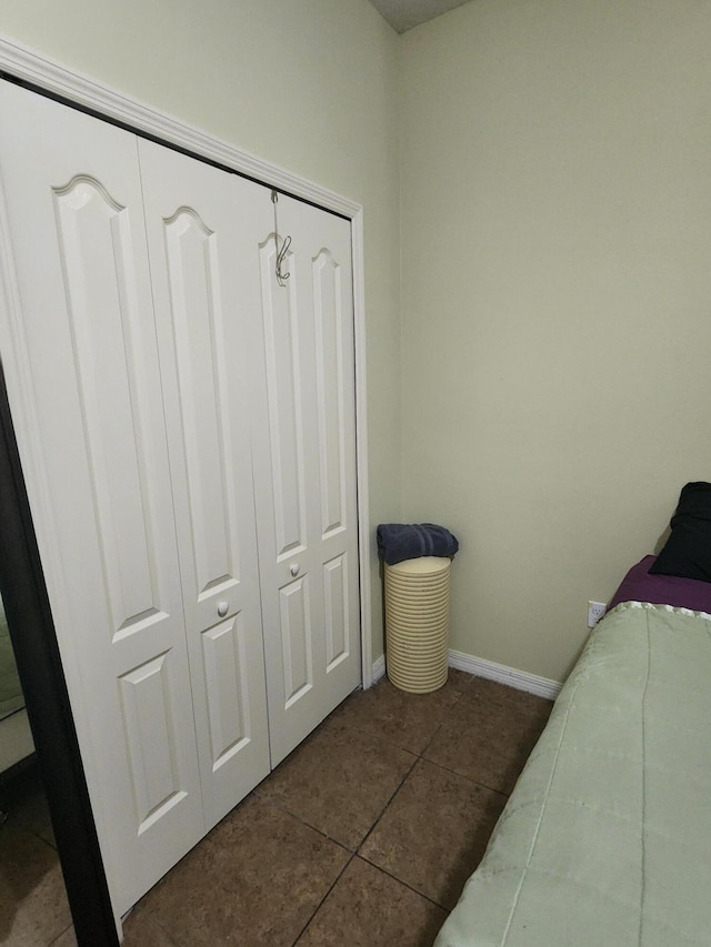 1691 SW Buttercup Ave, Port Saint Lucie, FL 34953 - bedroom with dark tile patterned floors, baseboards, and a closet