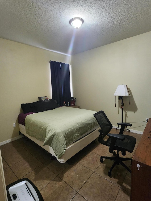1691 SW Buttercup Ave, Port Saint Lucie, FL 34953 - bedroom featuring baseboards, tile patterned flooring, and a textured ceiling