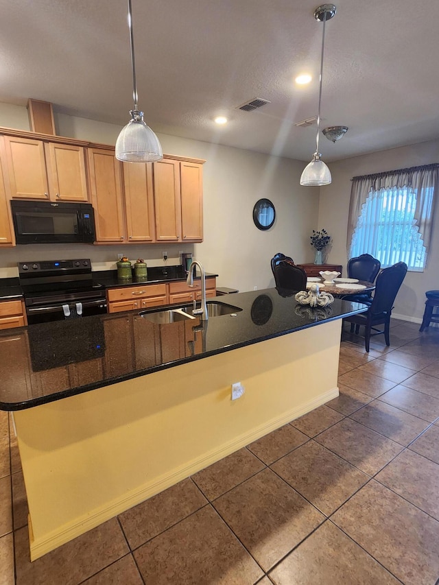 1691 SW Buttercup Ave, Port Saint Lucie, FL 34953 - kitchen with visible vents, dark tile patterned floors, a sink, black appliances, and decorative light fixtures