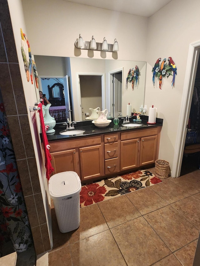 1691 SW Buttercup Ave, Port Saint Lucie, FL 34953 - ensuite bathroom featuring double vanity, a sink, connected bathroom, and tile patterned floors