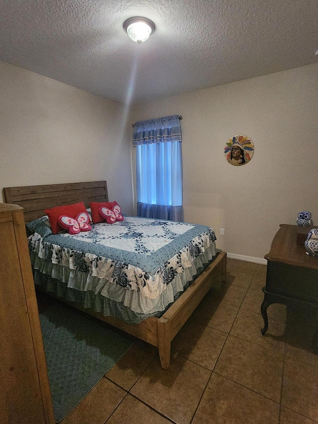 1691 SW Buttercup Ave, Port Saint Lucie, FL 34953 - bedroom featuring tile patterned flooring and a textured ceiling
