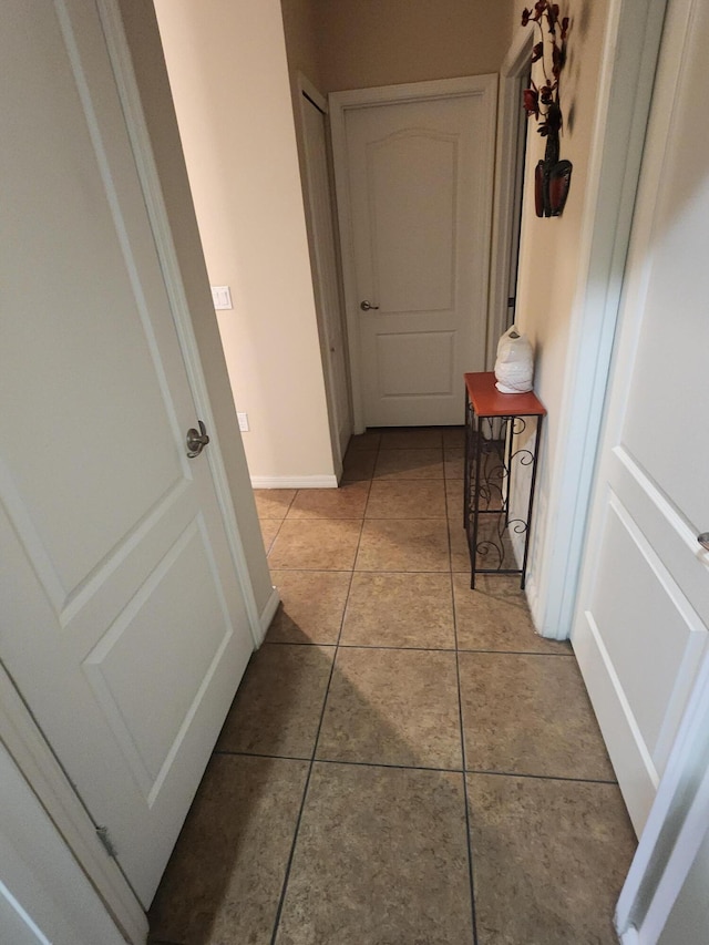 1691 SW Buttercup Ave, Port Saint Lucie, FL 34953 - hallway featuring baseboards and light tile patterned flooring
