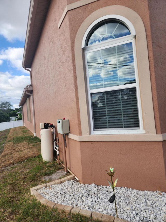 1691 SW Buttercup Ave, Port Saint Lucie, FL 34953 - view of property exterior with stucco siding and fence