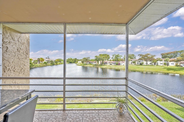 unfurnished sunroom with a water view