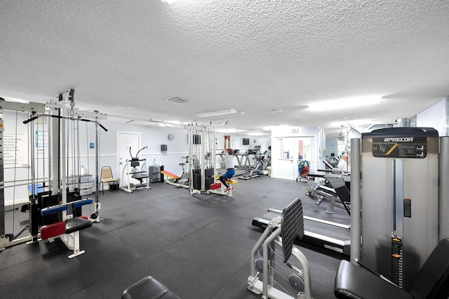 exercise room featuring a textured ceiling and visible vents