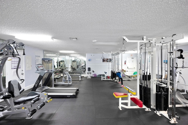 gym featuring a textured ceiling and visible vents
