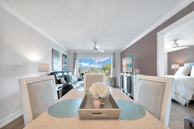 dining area featuring wood finished floors, a ceiling fan, and ornamental molding