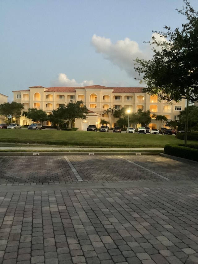 view of building exterior with uncovered parking
