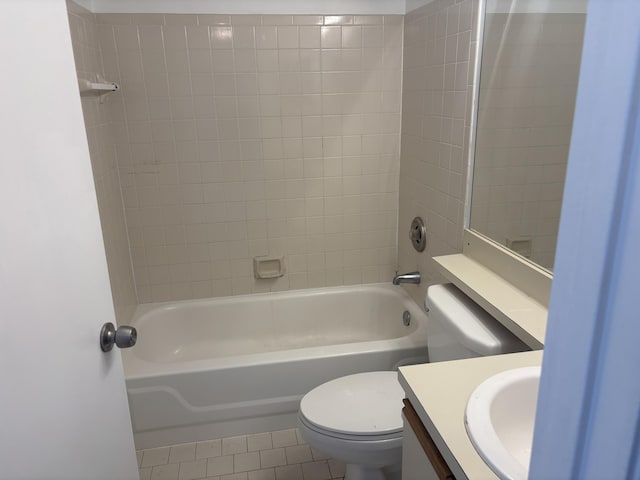 bathroom featuring tile patterned flooring, toilet, vanity, and shower / washtub combination