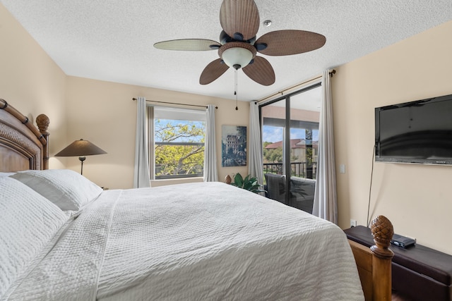bedroom featuring a textured ceiling, ceiling fan, and access to exterior