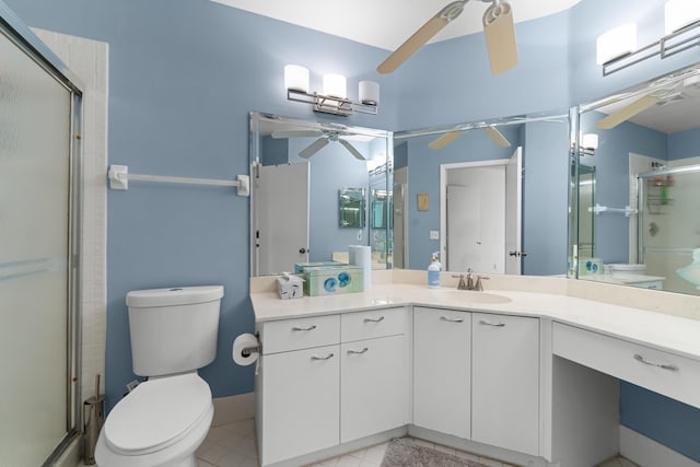 bathroom with a shower stall, tile patterned flooring, a ceiling fan, vanity, and toilet