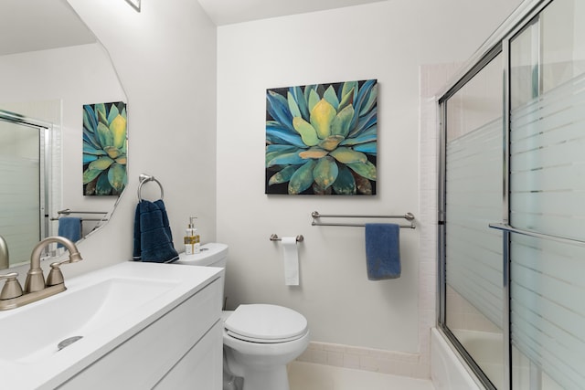 bathroom featuring baseboards, vanity, bath / shower combo with glass door, and toilet