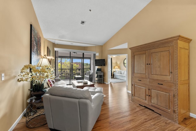 living area featuring light wood-type flooring, baseboards, and visible vents