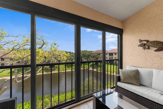 sunroom with a water view and an outdoor hangout area