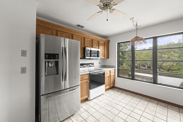 kitchen featuring a ceiling fan, visible vents, appliances with stainless steel finishes, hanging light fixtures, and light countertops