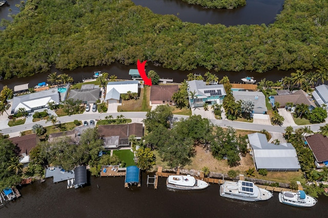 drone / aerial view featuring a water view and a view of trees