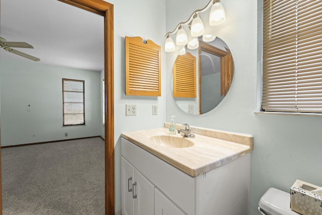 bathroom featuring vanity, a ceiling fan, and toilet