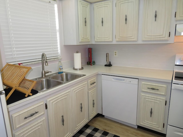 701 Lori Dr Unit 103, Palm Springs, FL 33461 - kitchen featuring dishwasher, a sink, light countertops, range, and light wood-type flooring
