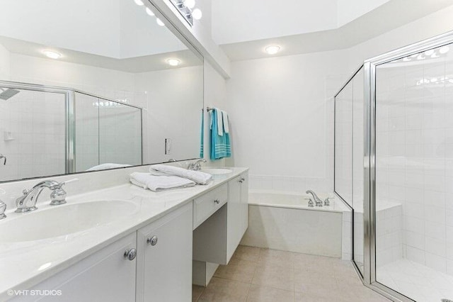 bathroom with double vanity, a sink, a bath, and a stall shower