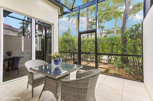 sunroom featuring outdoor dining space