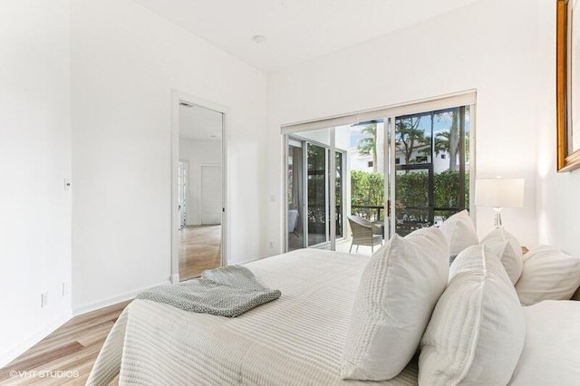 bedroom featuring light wood-type flooring and access to exterior