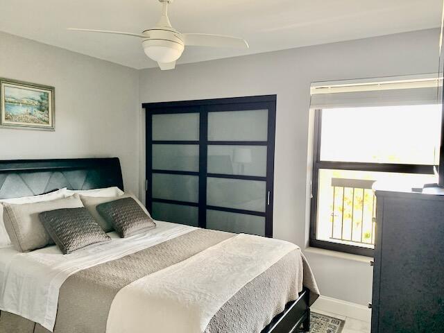 6562 Boca Del Mar Dr Unit 527, Boca Raton, FL 33433 - bedroom featuring baseboards and ceiling fan