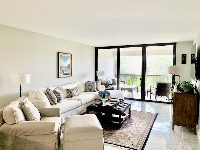 6562 Boca Del Mar Dr Unit 527, Boca Raton, FL 33433 - living room with light marble finish flooring and floor to ceiling windows