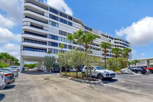 3589 S Ocean Blvd Unit 509, South Palm Beach, FL 33480 - view of apartment building / complex featuring uncovered parking