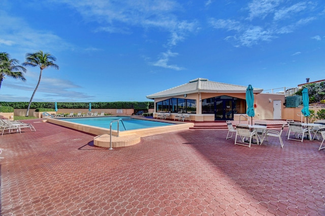 3589 S Ocean Blvd Unit 509, South Palm Beach, FL 33480 - community pool featuring a patio area and outdoor dining area
