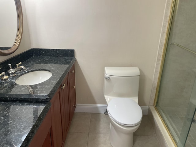 3589 S Ocean Blvd Unit 509, South Palm Beach, FL 33480 - full bath featuring vanity, toilet, tile patterned flooring, a shower stall, and baseboards
