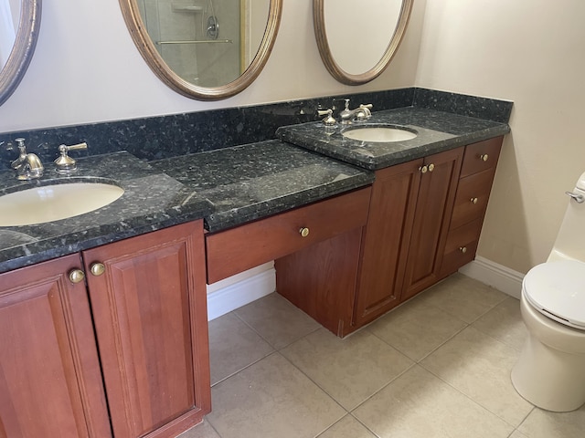 3589 S Ocean Blvd Unit 509, South Palm Beach, FL 33480 - bathroom with toilet, double vanity, tile patterned floors, and baseboards