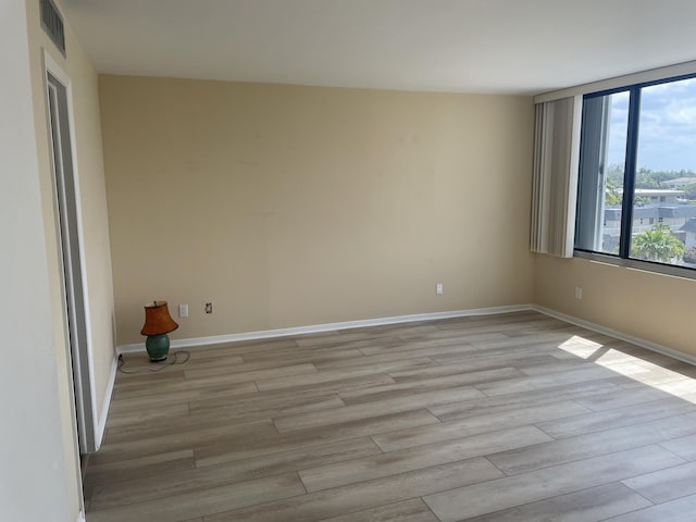 3589 S Ocean Blvd Unit 509, South Palm Beach, FL 33480 - spare room featuring light wood finished floors and baseboards