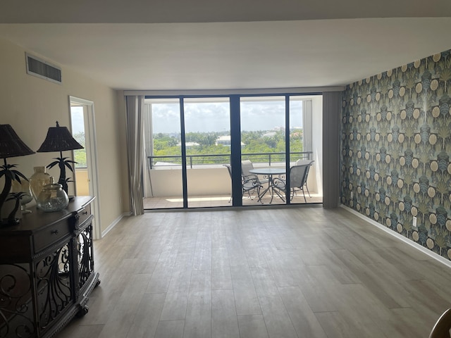 3589 S Ocean Blvd Unit 509, South Palm Beach, FL 33480 - unfurnished room featuring wood finished floors and baseboards